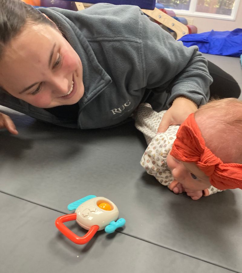 A girl climbing a rock wall as part of Physical Therapy.